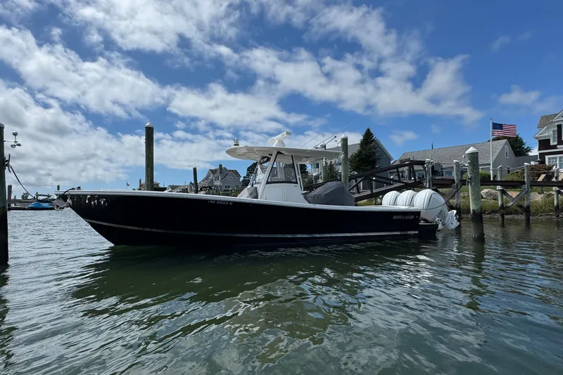 Slide: The Image of 2023 Regulator 34 Center Console boat docked on a sunny day. - 3