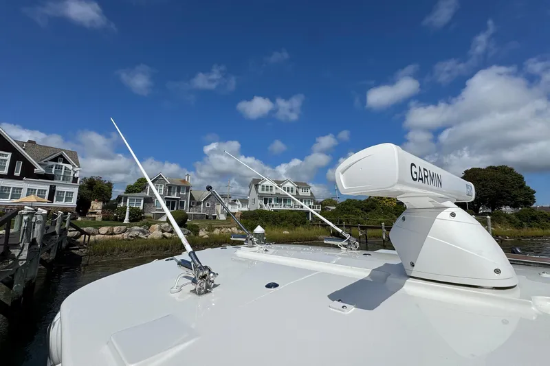 Slide: The Image of 2023 Regulator 34 Center Console with Garmin radar, docked near waterfront homes. - 31