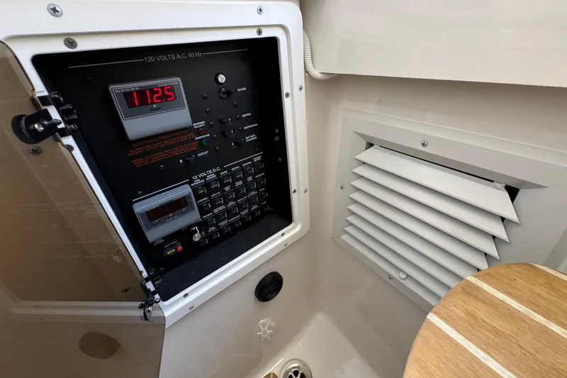 Slide: The Image of Electrical panel inside 2023 Regulator 34 Center Console boat, showing voltage display and controls. - 37