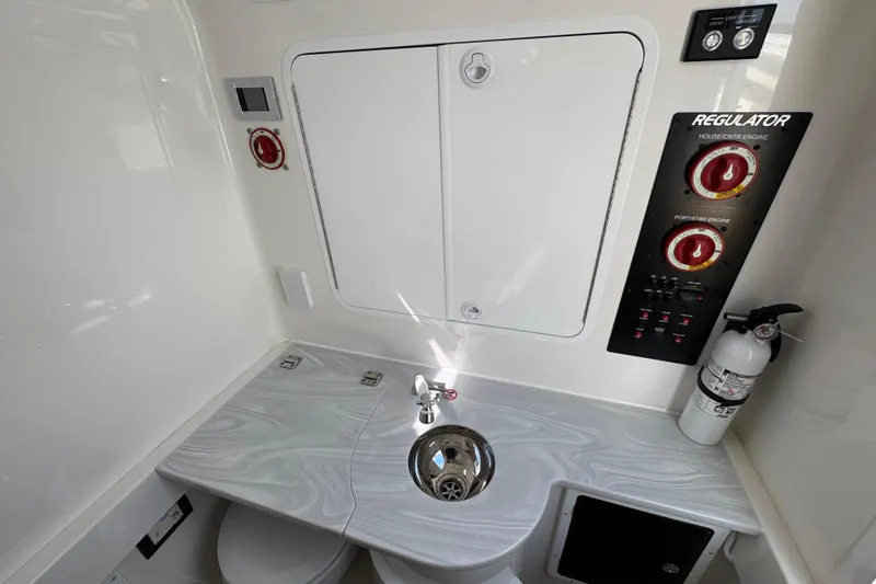 Slide: The Image of 2023 Regulator 34 Center Console interior with control panel, sink, and fire extinguisher. - 38