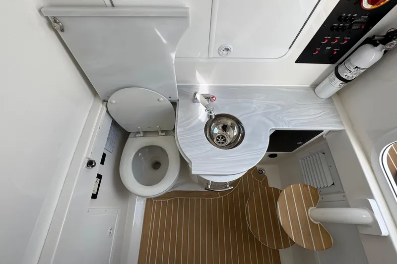 Slide: The Image of 2023 Regulator 34 Center Console boat interior with toilet and sink. - 39