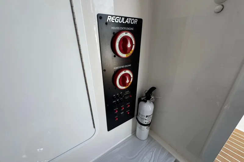 Slide: The Image of Control panel and fire extinguisher on 2023 Regulator 34 Center Console boat. - 40