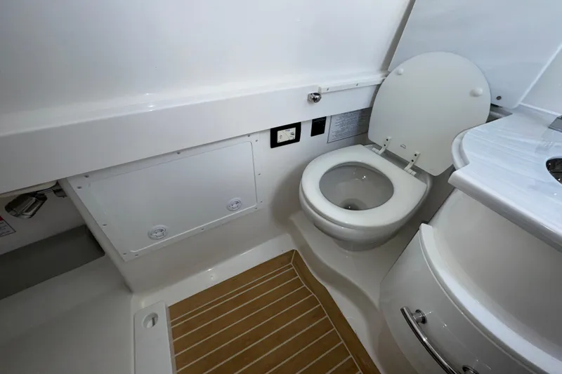Slide: The Image of 2023 Regulator 34 Center Console boat bathroom with toilet and sink. - 42