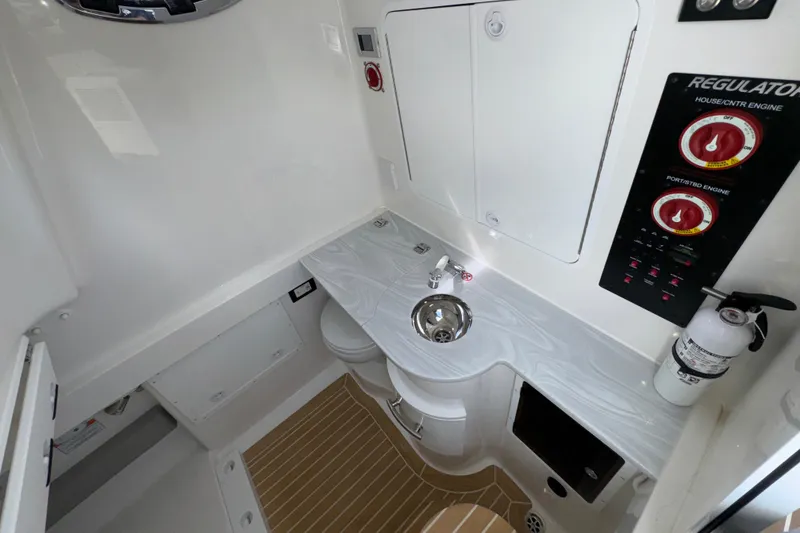 Slide: The Image of 2023 Regulator 34 Center Console interior with sink, controls, and fire extinguisher. - 45