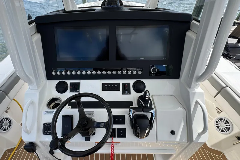 Slide: The Image of 2023 Regulator 34 Center Console helm with dual displays and modern controls. - 46