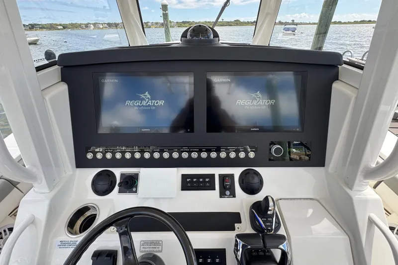 Slide: The Image of 2023 Regulator 34 Center Console helm with dual Garmin displays and controls. - 49