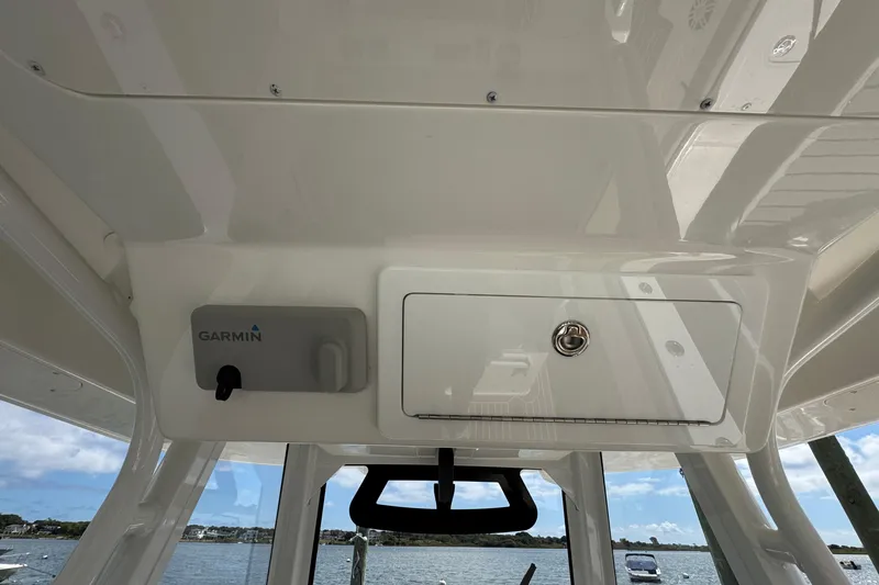Slide: The Image of 2023 Regulator 34 Center Console helm with Garmin electronics and storage compartment. - 55