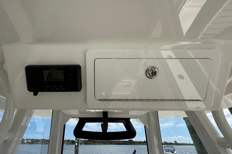 Slide: The Image of 2023 Regulator 34 Center Console helm with Garmin display and storage compartment. - 56