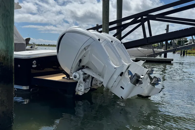 Slide: The Image of 2023 Regulator 34 Center Console with dual outboard engines at a dock. - 6