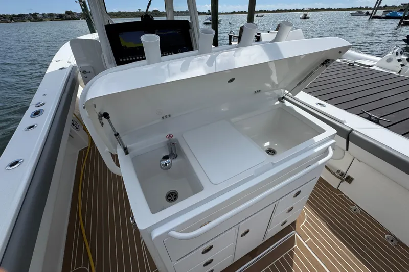 Slide: The Image of 2023 Regulator 34 Center Console boat with open sink and storage area. - 61