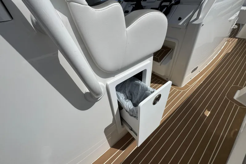 Slide: The Image of 2023 Regulator 34 Center Console boat with open storage compartment on deck. - 63