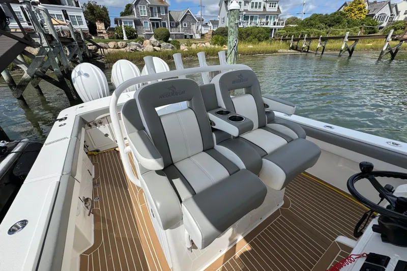 Slide: The Image of 2023 Regulator 34 Center Console boat interior with luxurious seating and scenic waterfront view. - 64