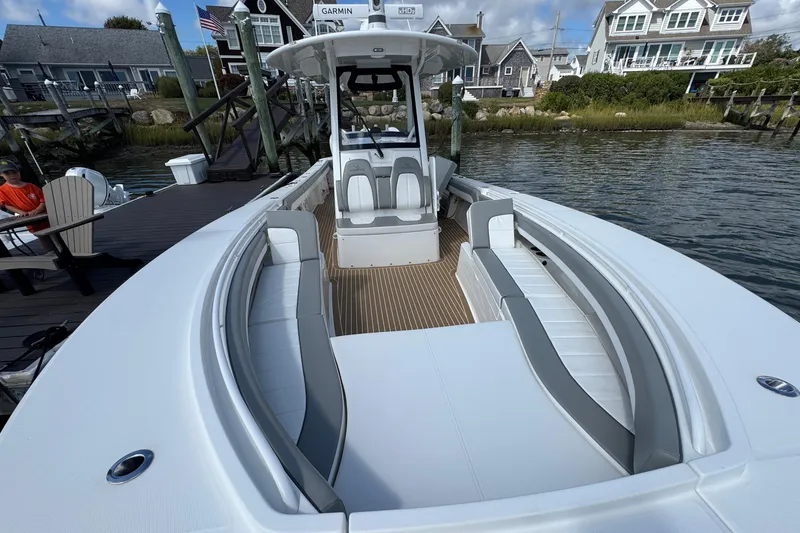 Slide: The Image of 2023 Regulator 34 Center Console boat docked, featuring spacious seating and modern design. - 70