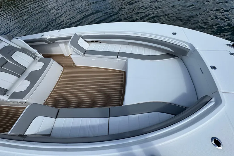 Slide: The Image of 2023 Regulator 34 Center Console boat interior with cushioned seating and wood-style flooring. - 71
