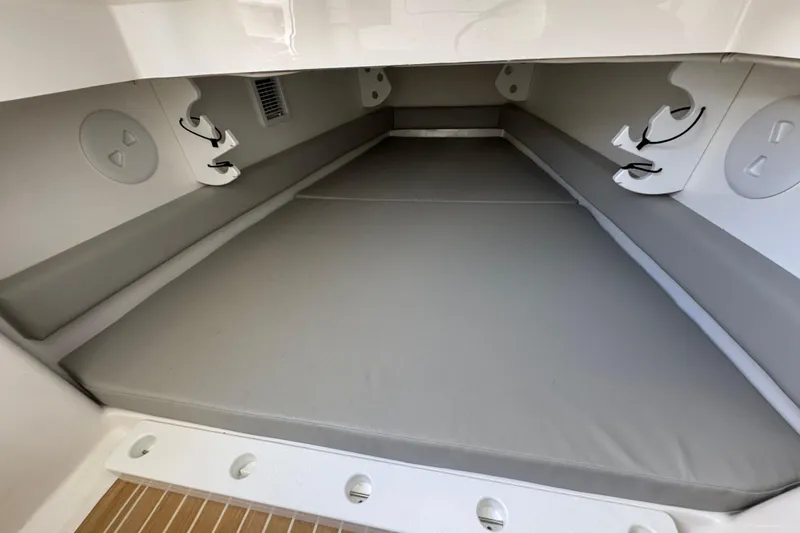 Slide: The Image of 2023 Regulator 34 Center Console cabin interior with cushioned seating and storage. - 72