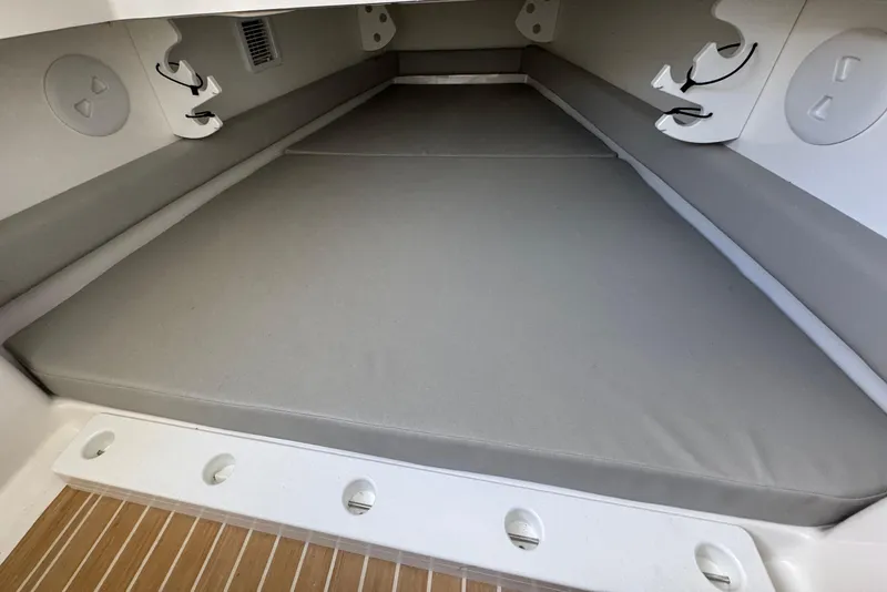 Slide: The Image of 2023 Regulator 34 Center Console cabin interior with cushioned seating and storage hooks. - 73