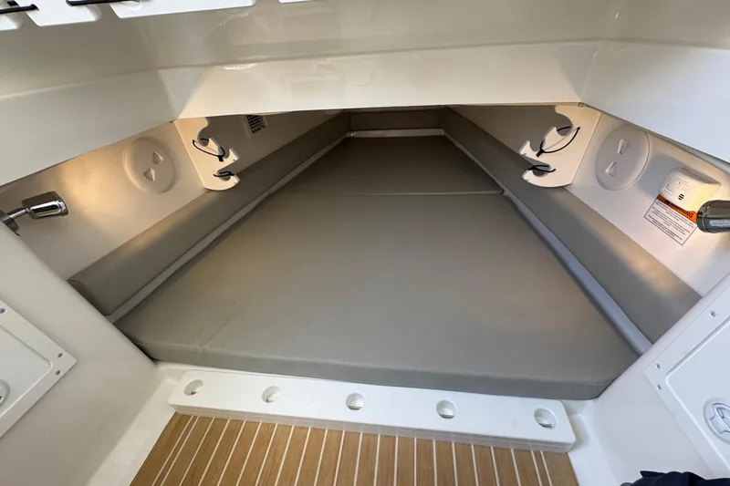 Slide: The Image of 2023 Regulator 34 Center Console cabin interior with cushioned sleeping area. - 75