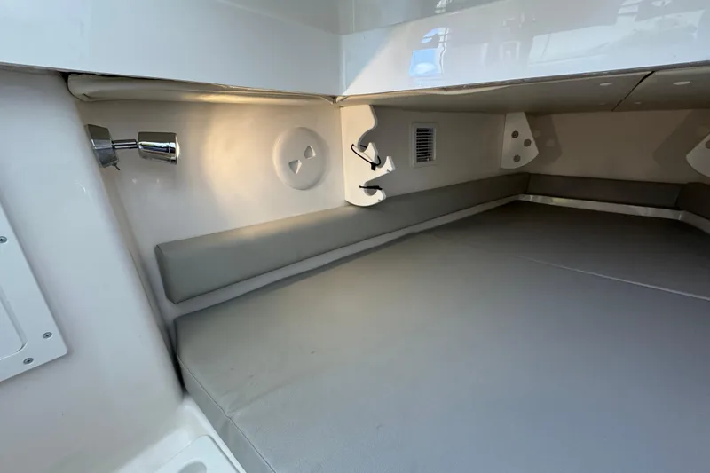 Slide: The Image of 2023 Regulator 34 Center Console cabin interior with cushioned seating and ambient lighting. - 76