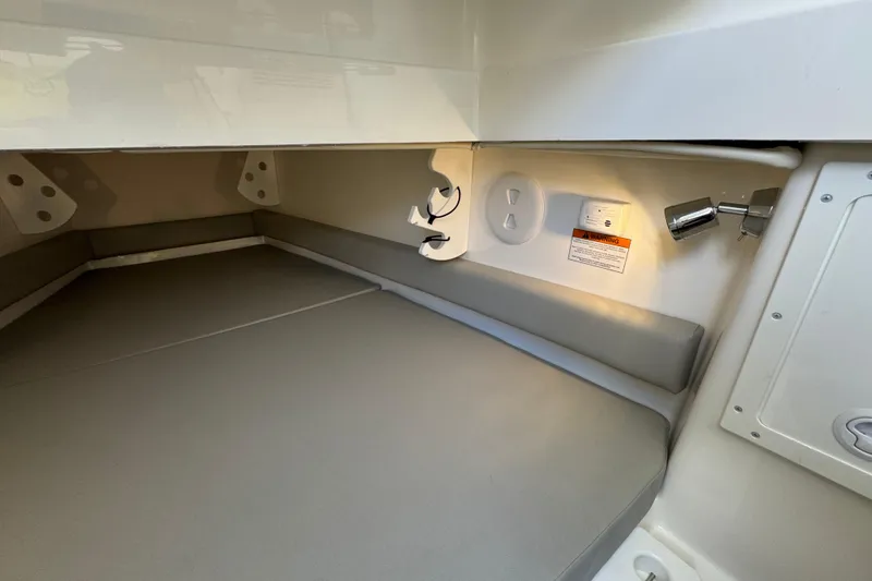 Slide: The Image of 2023 Regulator 34 Center Console cabin interior with cushioned seating and lighting. - 77