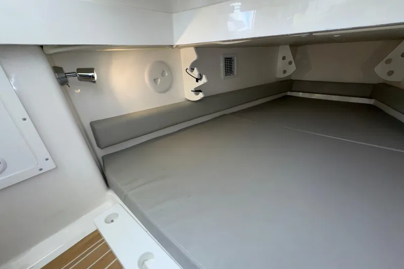 Slide: The Image of 2023 Regulator 34 Center Console cabin interior with cushioned seating and modern lighting. - 78