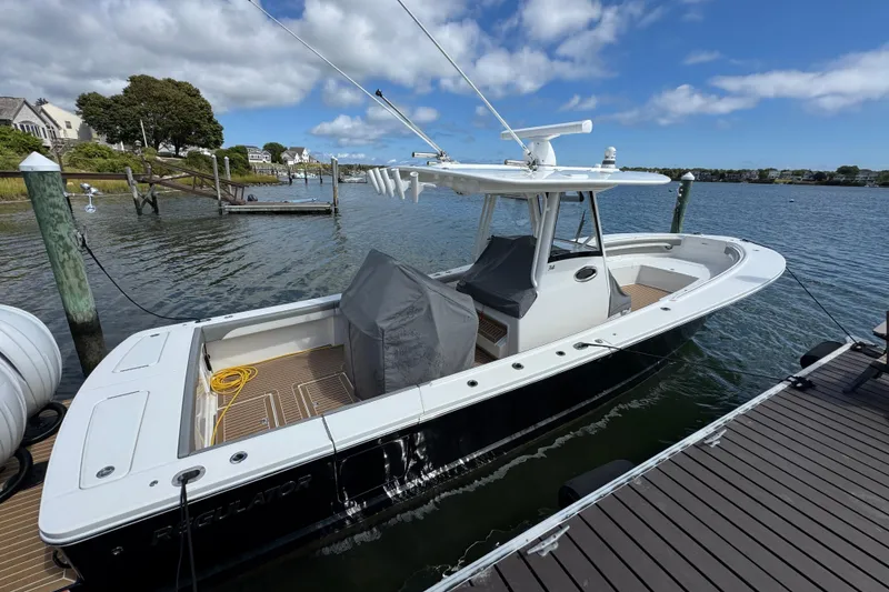 Slide: The Image of 2023 Regulator 34 Center Console boat docked on a sunny day. - 8