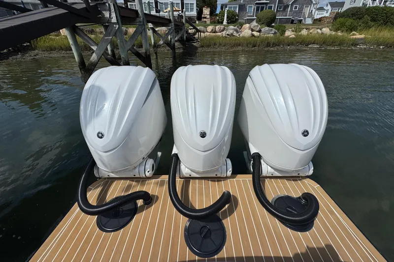 Slide: The Image of Triple outboard engines on a 2023 Regulator 34 Center Console boat at dock. - 83