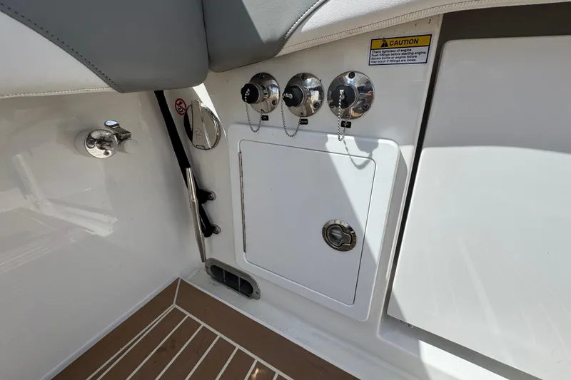Slide: The Image of 2023 Regulator 34 Center Console boat interior with control panel and caution label. - 86