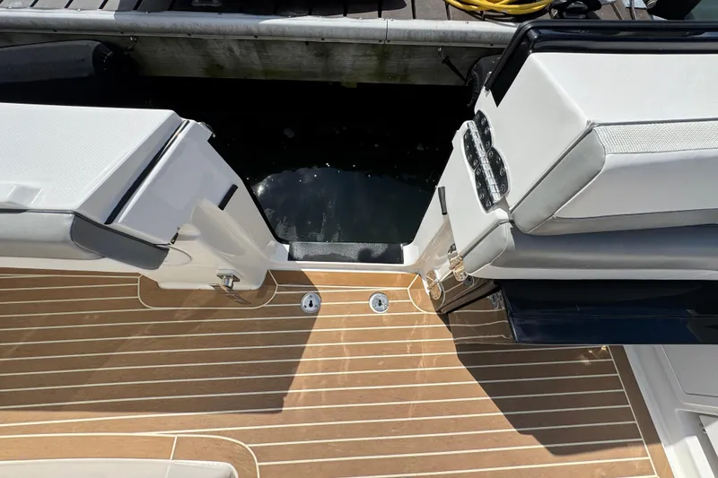 Slide: The Image of 2023 Regulator 34 Center Console boat with teak deck and cushioned seating. - 88