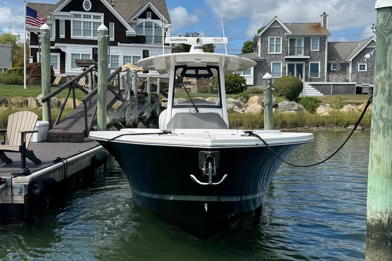 Slide: The Image of 2023 Regulator 34 Center Console boat docked near waterfront homes. - 9