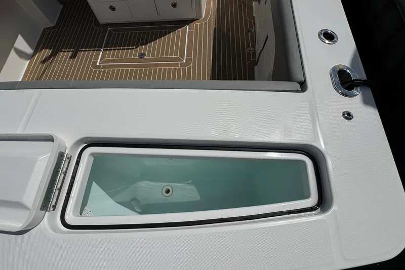 Slide: The Image of 2023 Regulator 34 Center Console boat deck with livewell and storage compartments. - 90
