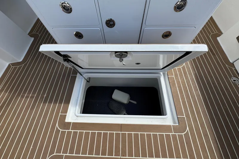 Slide: The Image of Open storage compartment on 2023 Regulator 34 Center Console boat deck. - 94