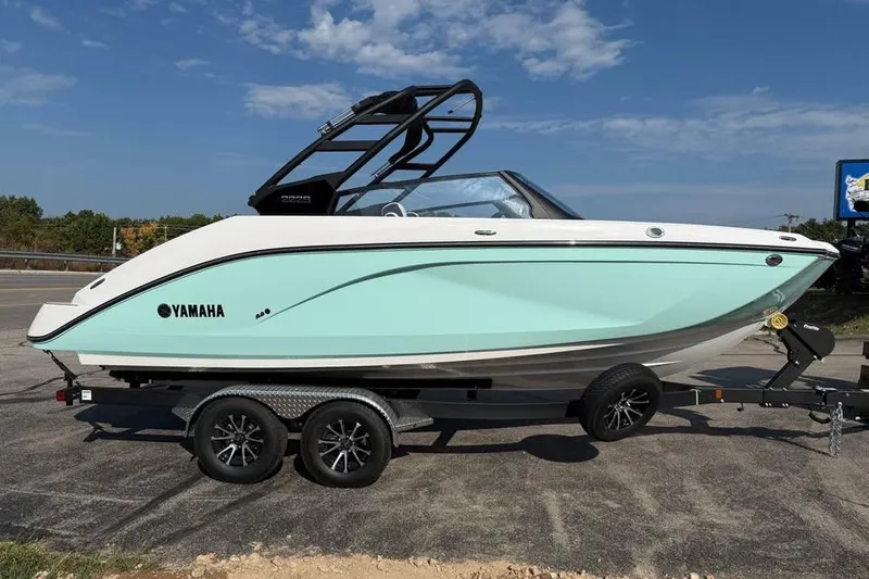 The Image of 2026 Yamaha Boats 222S on trailer, sleek design, light blue hull, sunny day. - 0
