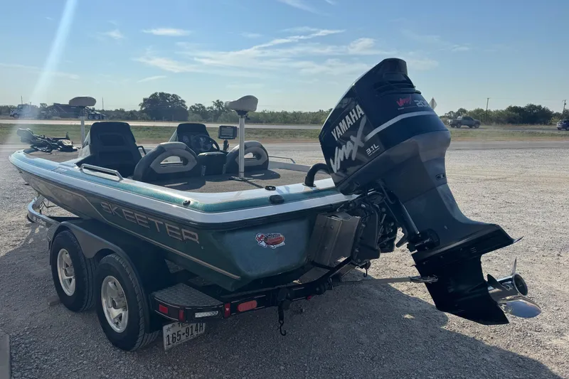 Slide: The Image of 2000 Skeeter ZX200 boat with Yamaha VMAX engine on a trailer in a parking lot. - 3