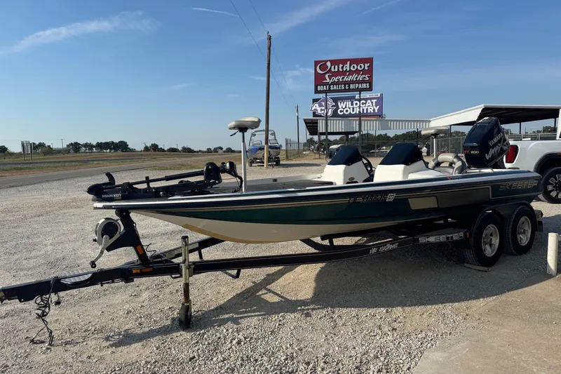 Slide: The Image of 2000 Skeeter ZX200 boat on trailer at outdoor sales and repair shop. - 4
