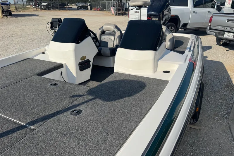 Slide: The Image of 2000 Skeeter ZX200 boat interior with dual consoles and seating, parked outdoors. - 6