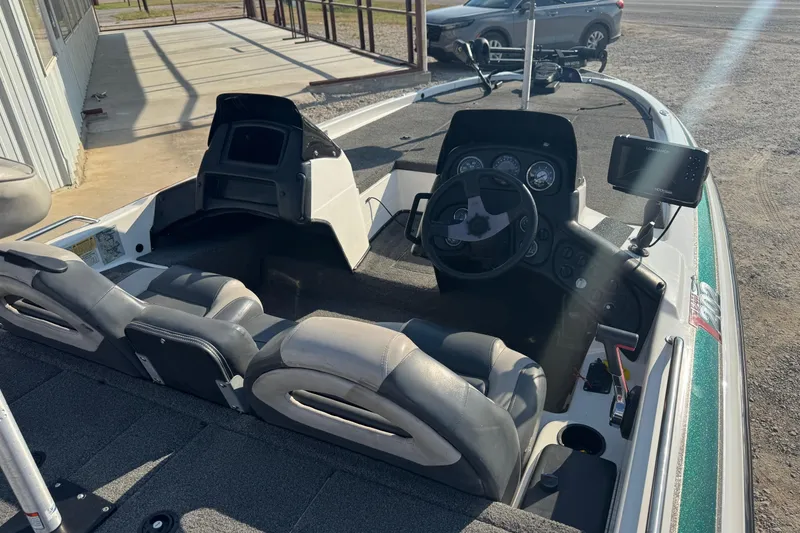 Slide: The Image of 2000 Skeeter ZX200 boat interior with steering wheel, seats, and navigation equipment. - 9