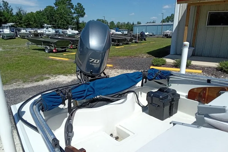 Slide: The Image of 1985 Boston Whaler 150 Sport with Yamaha 70 outboard motor in a boatyard. - 7