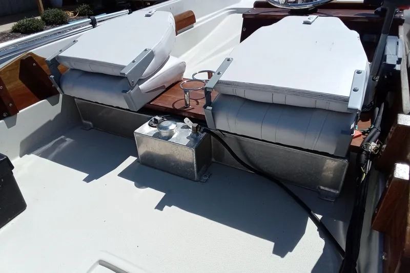 Slide: The Image of 1985 Boston Whaler 150 Sport interior with seating and metal fuel tank. - 9