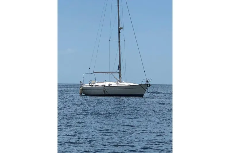 The Image of Sailboat Bavaria 43 Cruiser 2001 anchored on calm sea under clear blue sky. - 0