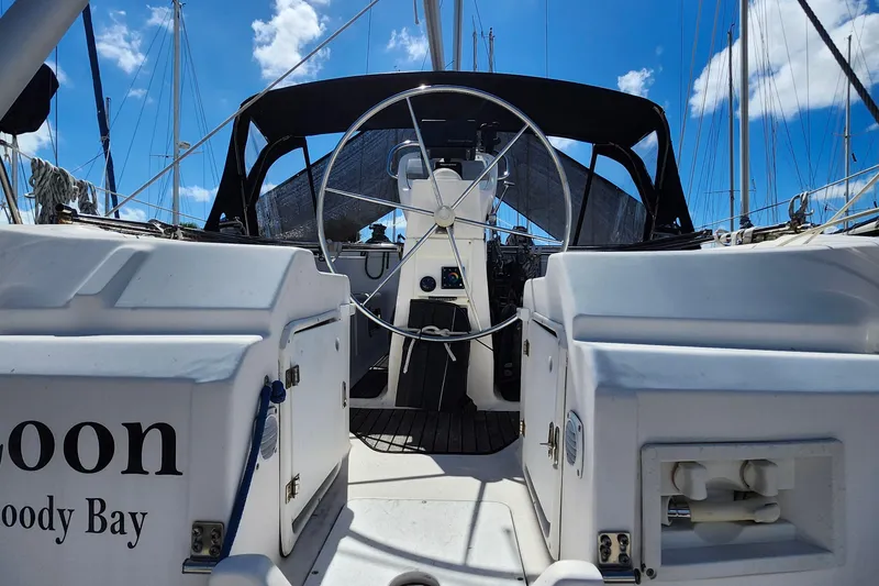 Slide: The Image of Cockpit view of a 2001 Bavaria 43 Cruiser sailboat under a clear blue sky. - 10