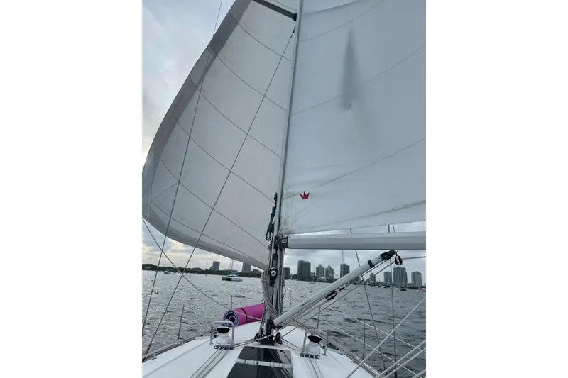 Slide: The Image of Sailing on a 2001 Bavaria 43 Cruiser with city skyline in the background. - 11