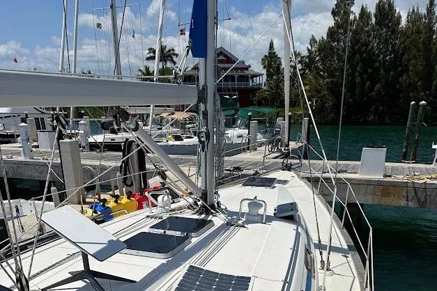 Slide: The Image of Sailboat Bavaria 42 (2001) docked at marina with clear skies and lush surroundings. - 20