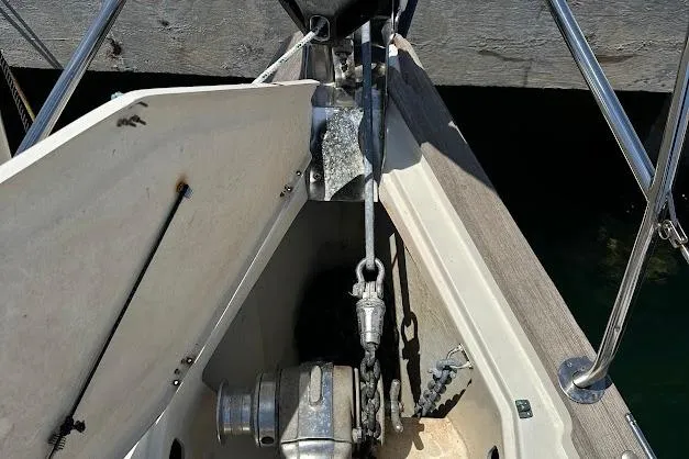 Slide: The Image of Anchor compartment of a 2001 Bavaria 42 sailboat, featuring a winch and chain. - 22