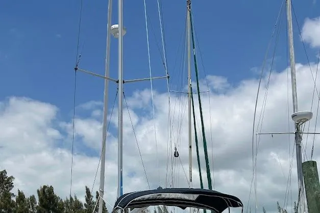 Slide: The Image of Sailboat Bavaria 42, 2001 model, docked under a clear blue sky. - 28