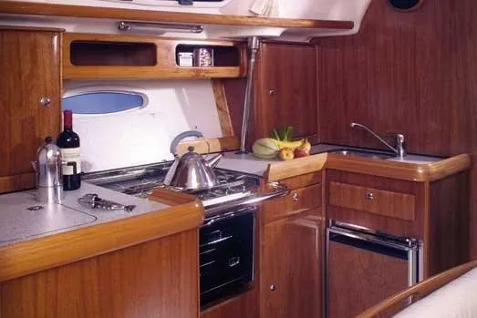 Slide: The Image of Luxurious wooden kitchen interior of 2001 Bavaria 43 Cruiser yacht with modern amenities. - 31