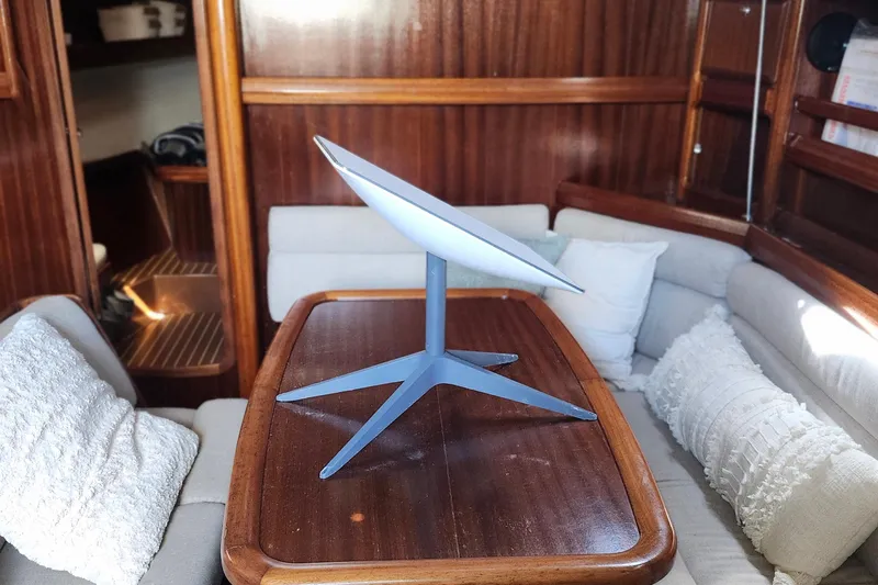 Slide: The Image of Interior of 2001 Bavaria 43 Cruiser yacht with modern satellite dish on table. - 33