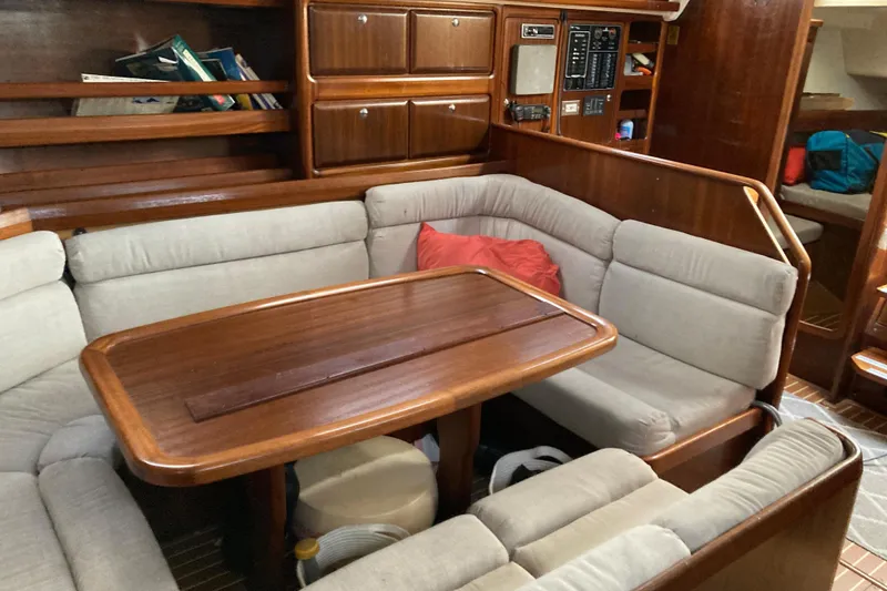 Slide: The Image of Cozy interior of 2001 Bavaria 43 Cruiser sailboat with wooden table and cushioned seating. - 34