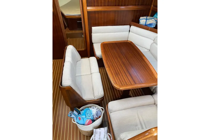 Slide: The Image of Interior of 2001 Bavaria 43 Cruiser yacht with wooden table and cushioned seating. - 37