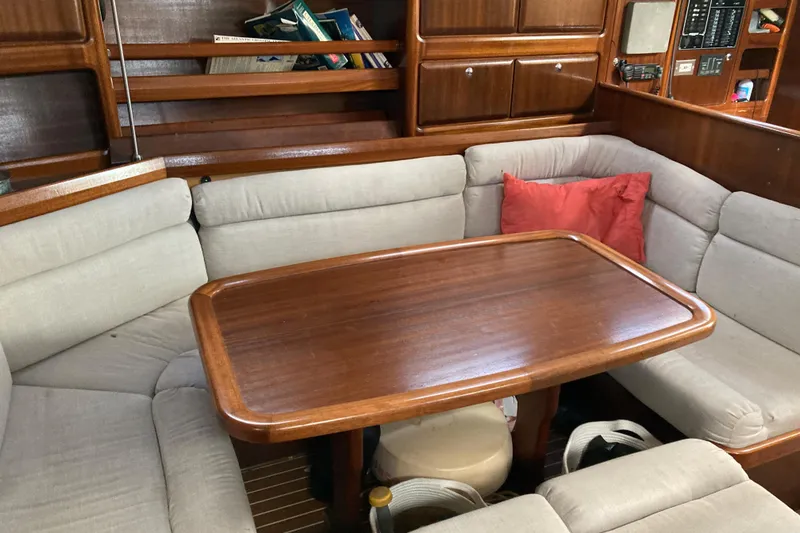 Slide: The Image of Cozy interior of 2001 Bavaria 43 Cruiser with wooden table and cushioned seating. - 38