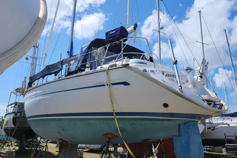 Slide: The Image of Bavaria 43 Cruiser 2001 sailboat on dry dock, surrounded by other yachts. - 4